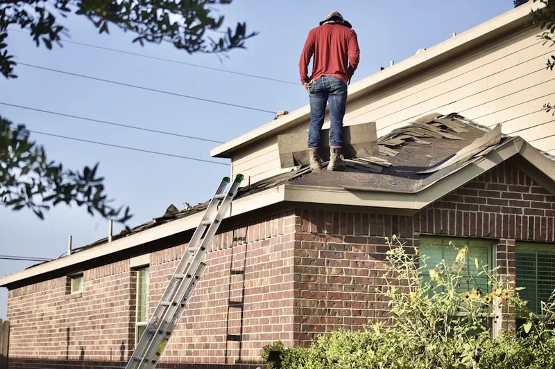 Professional roofer working on a residential roof in Galesburg